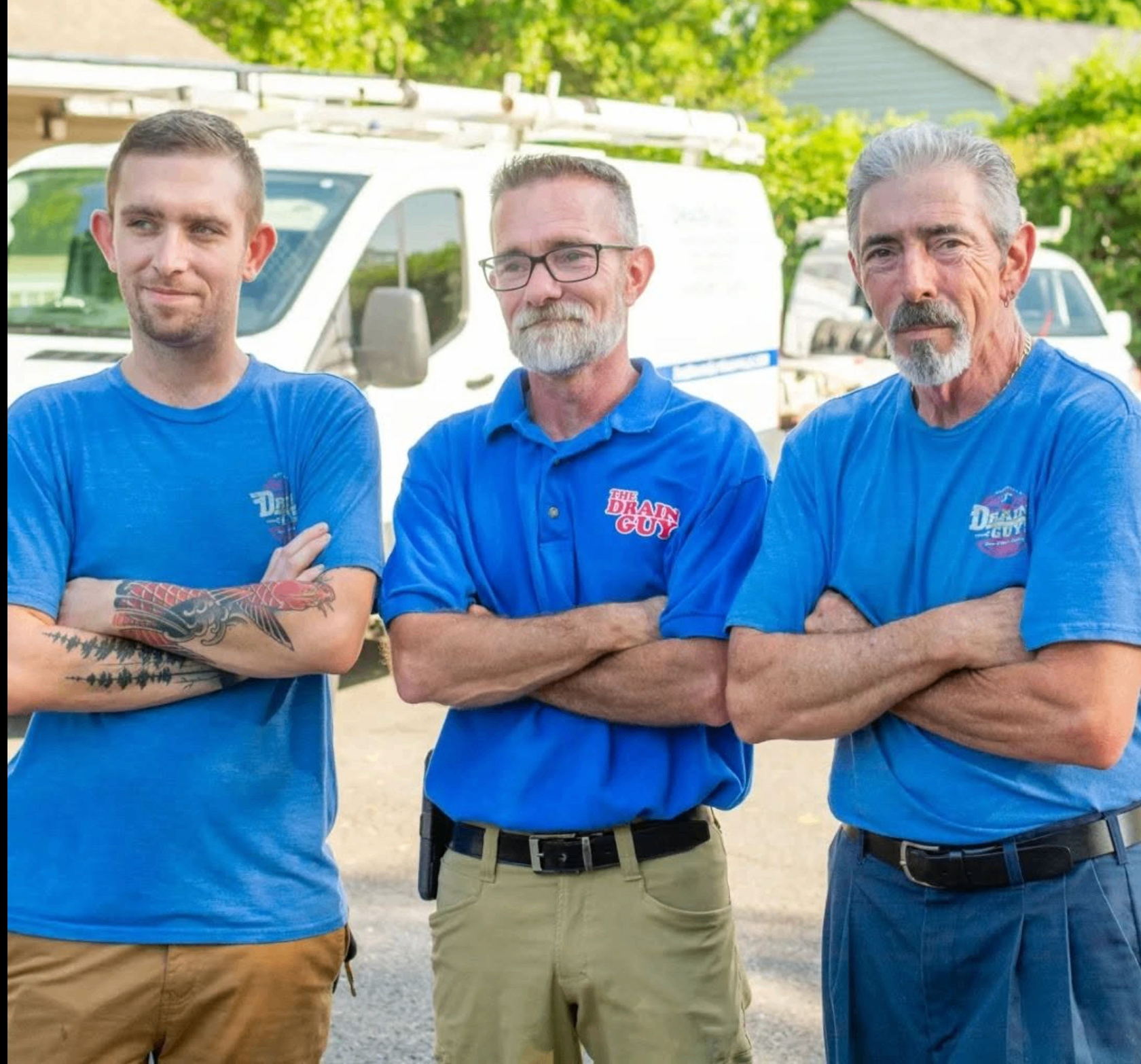Drain Guy crew members standing together in branded uniforms