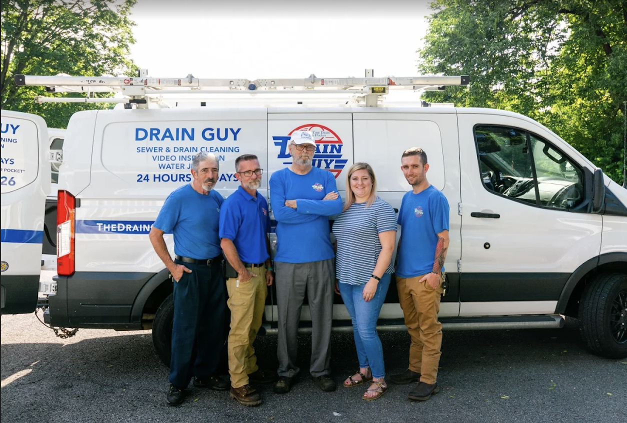 Drain Guy LLC team standing in front of a branded service van in Nashville